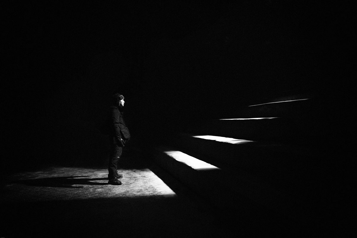 man at the bottom of dark staircasee