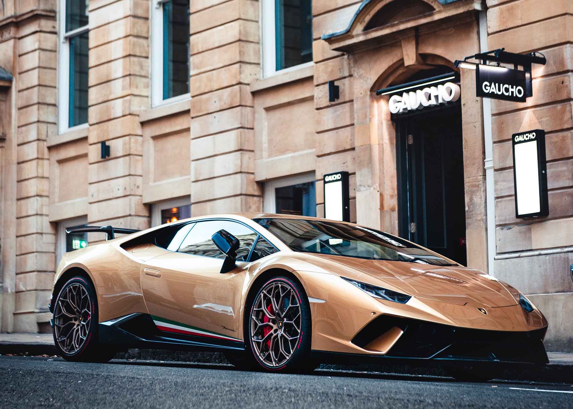 Luxury car parked in front of a luxury goods store