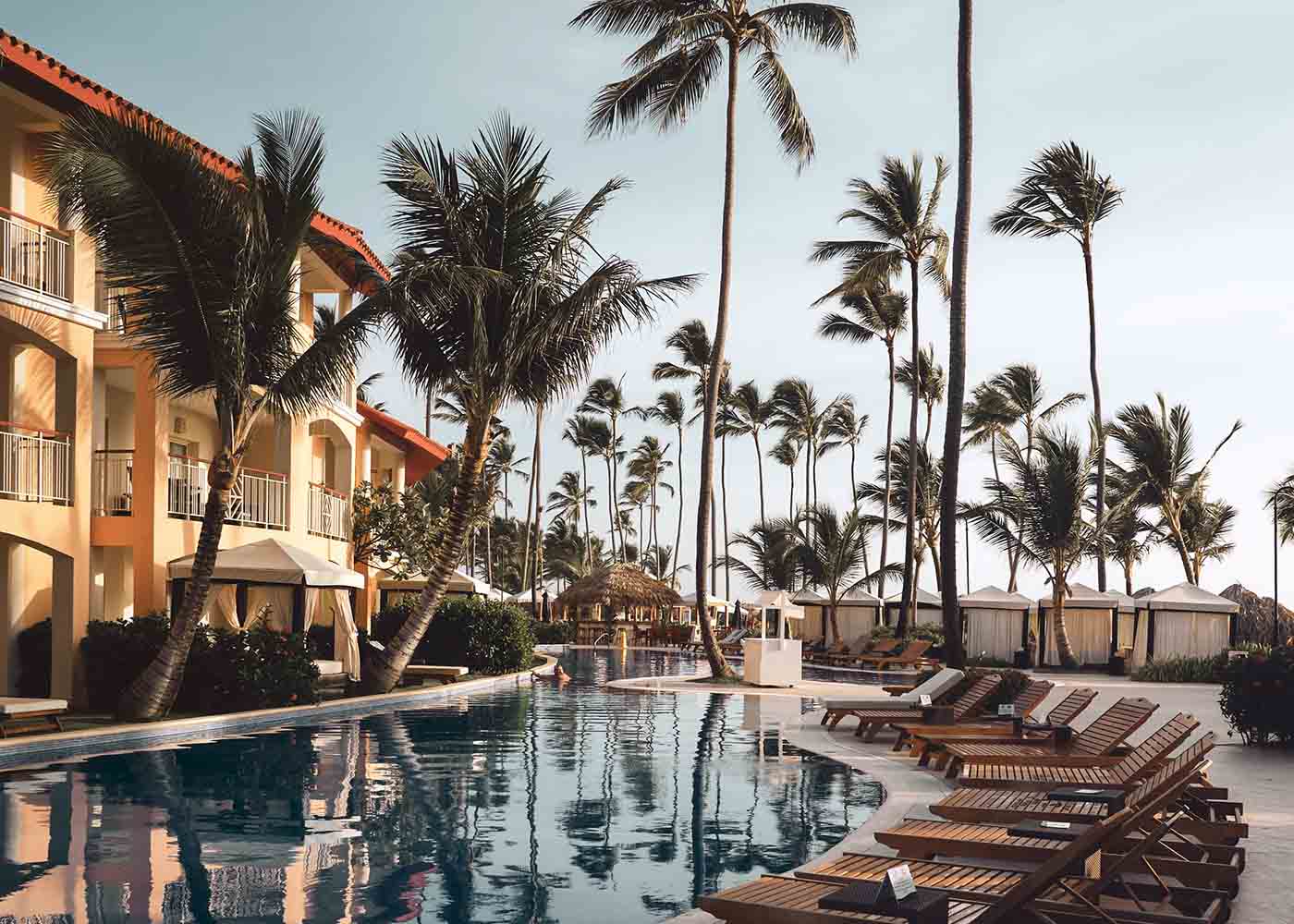 Pool at a luxury condo surrounded by palm trees