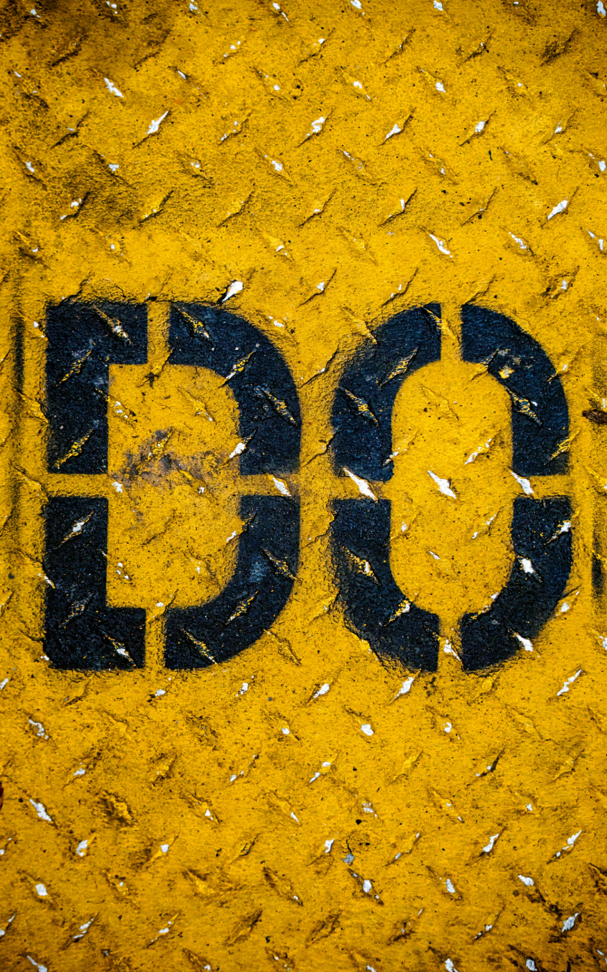 Steel floor painted yellow with the word DO in black