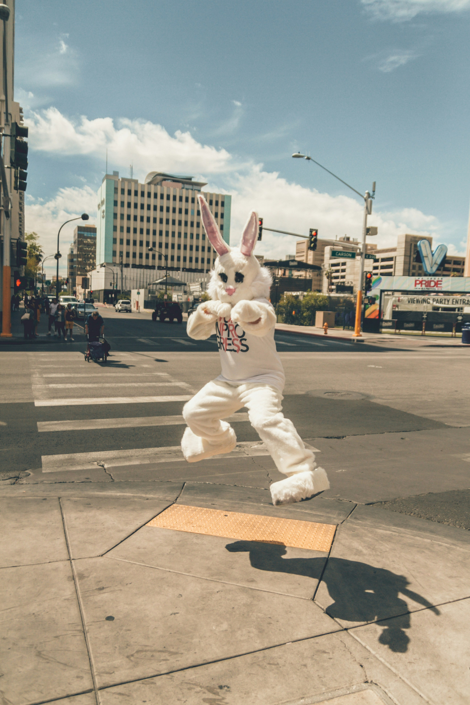 A rabbit mascot jumping by the side of the road