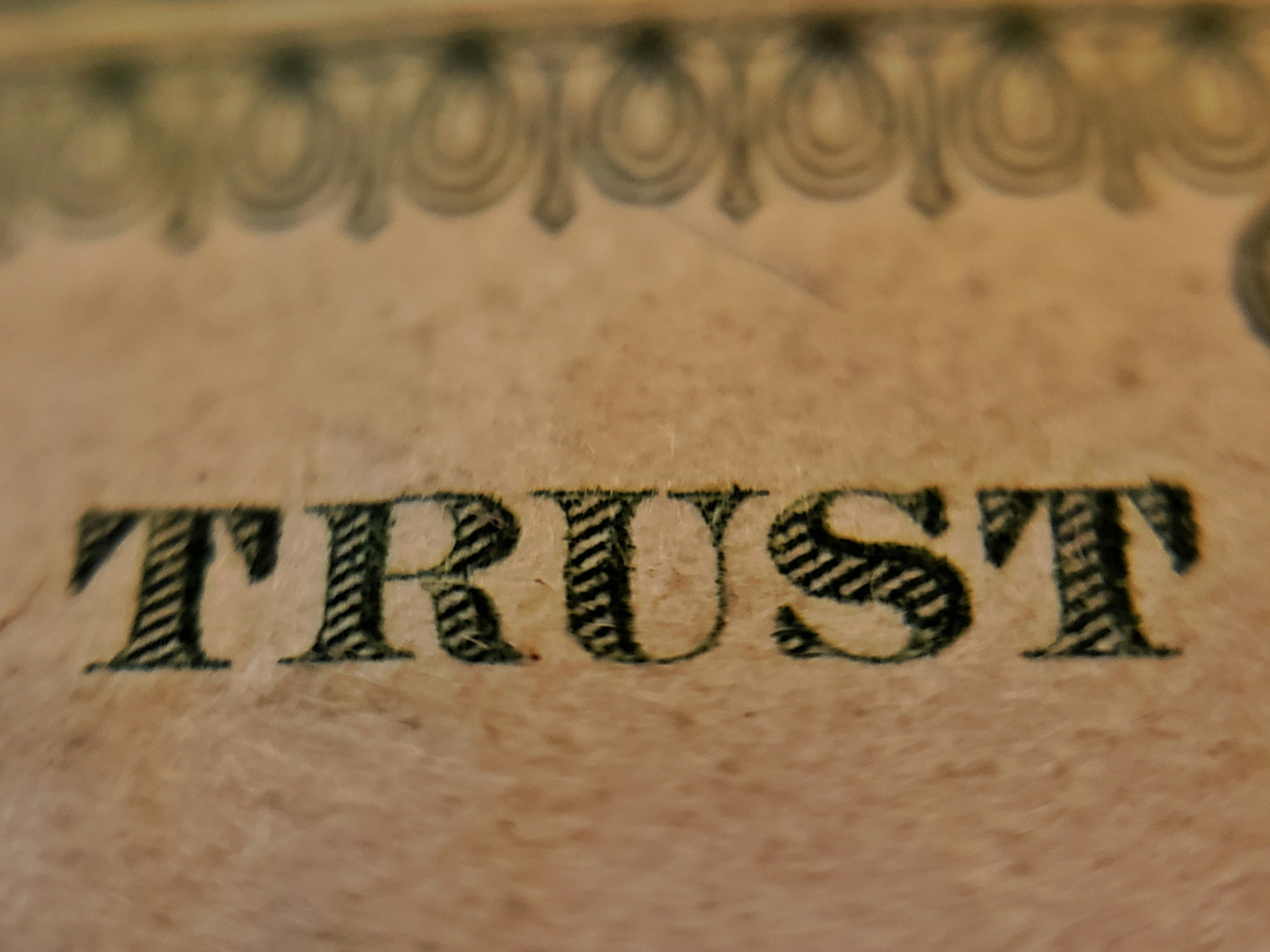 Close up on the word TRUST on a dollar bill