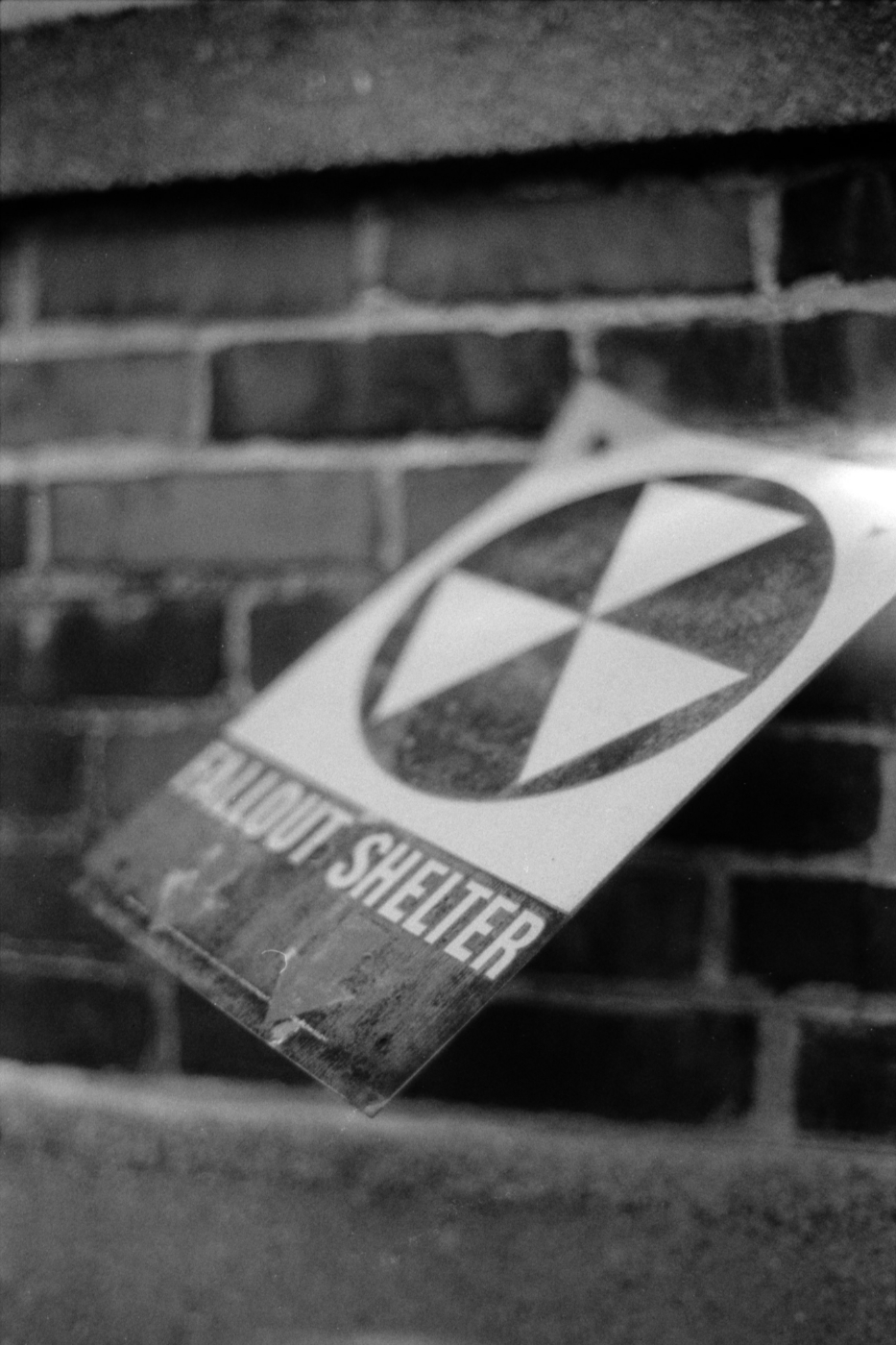 Gray scale photo of a fallout shelter knocked off a wall