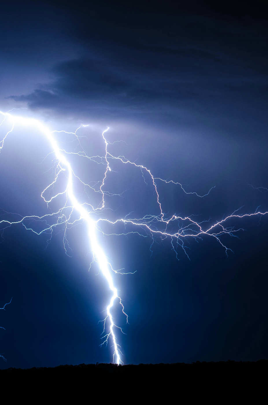 Lightning striking the land at night