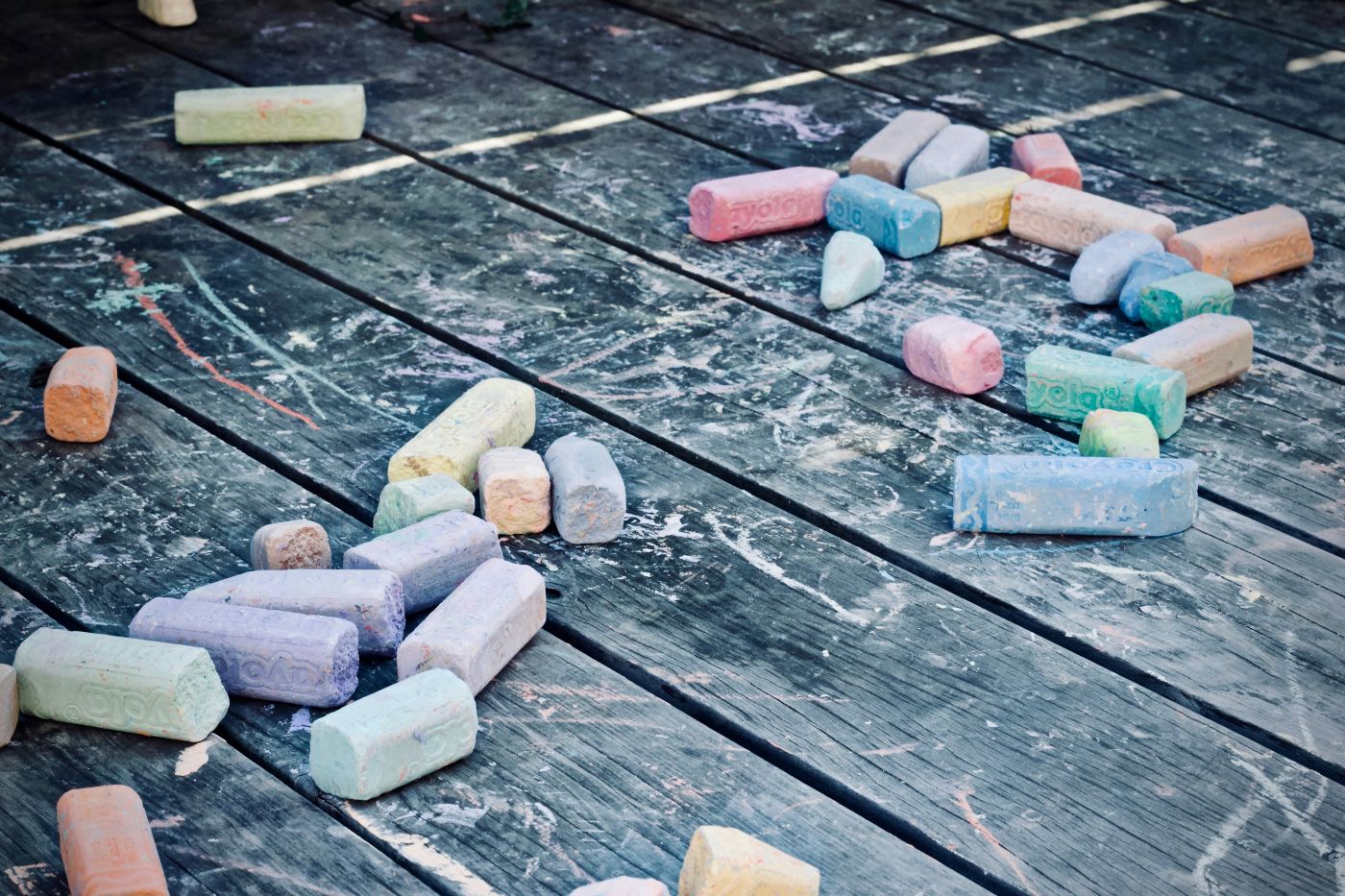 Assorted colors chalk on a black wood surface