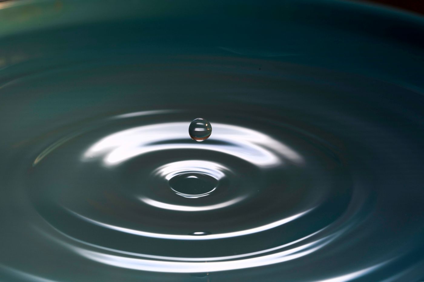 The circles around a drop of water with a drop suspended