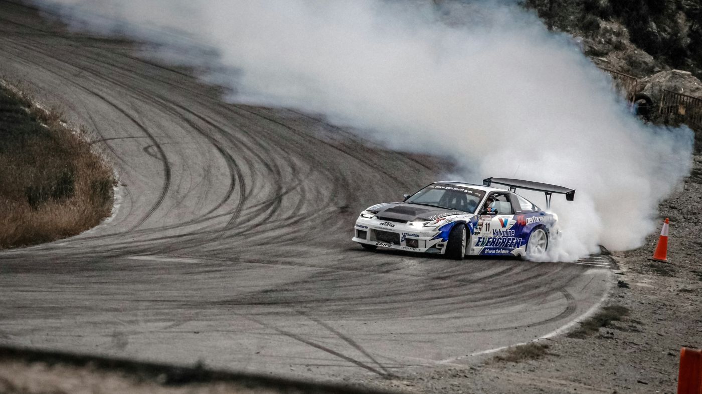 A blue and white race car drifting